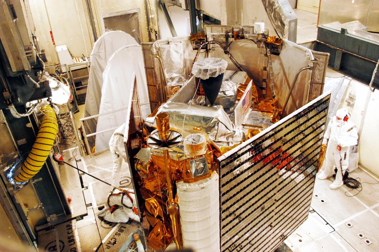 KENNEDY SPACE CENTER, FLA. - On Launch Pad 17-B at Cape Canaveral Air Force Station, the MESSENGER (Mercury Surface, Space Environment, Geochemistry and Ranging) spacecraft is prepared for installation of the fairing, a molded structure that fits flush with the outside surface of the Delta II upper stage booster and forms an aerodynamically smooth joint, protecting the spacecraft during launch.  Seen at right is one of the solar panels on the spacecraft.  MESSENGER  is scheduled to launch Aug. 2 aboard a Boeing Delta II rocket and is expected to enter Mercury orbit in March 2011.  MESSENGER was built for NASA by the Johns Hopkins University Applied Physics Laboratory in Laurel, Md.