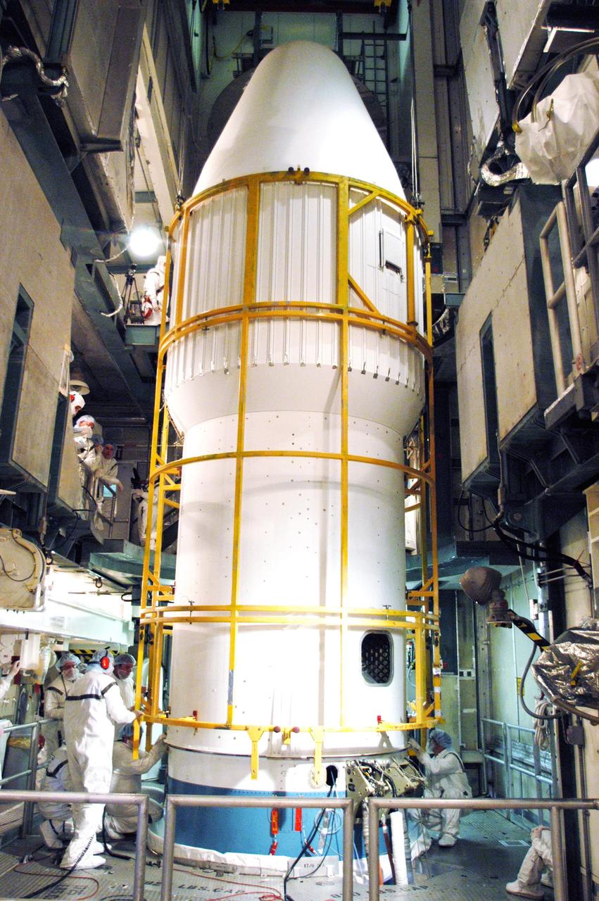KENNEDY SPACE CENTER, FLA. - On Launch Pad 17-B at Cape Canaveral Air Force Station, Boeing workers complete the installation of the fairing around the MESSENGER (Mercury Surface, Space Environment, Geochemistry and Ranging) spacecraft.  The fairing is a molded structure that fits flush with the outside surface of the upper stage booster and forms an aerodynamically smooth joint, protecting the spacecraft during launch.  MESSENGER  is scheduled to launch Aug. 2 aboard a Boeing Delta II rocket and is expected to enter Mercury orbit in March 2011.  MESSENGER was built for NASA by the Johns Hopkins University Applied Physics Laboratory in Laurel, Md.