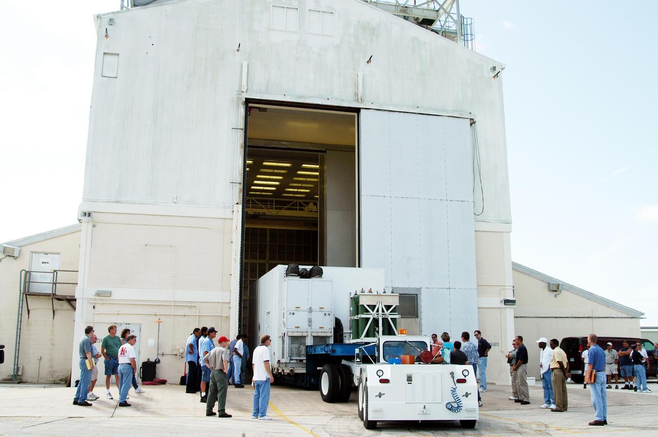 KENNEDY SPACE CENTER, FLA. - - The Swift spacecraft arrives at Hangar AE at Cape Canaveral Air Force Station (CCAFS). Swift is a first-of-its-kind, multi-wavelength observatory dedicated to the study of gamma-ray burst (GRB) science. Its three instruments will work together to observe GRBs and afterglows in the gamma-ray, X-ray and optical wavebands. Swift is part of NASA’s medium explorer (MIDEX) program being developed by an international collaboration. It will be launched no earlier than Oct. 7 into a low-Earth orbit on a Boeing Delta 7320 rocket from pad 17-A at CCAFS. During its nominal 2-year mission, Swift is expected to observe more than 200 bursts, which will represent the most comprehensive study of GRB afterglow to date.