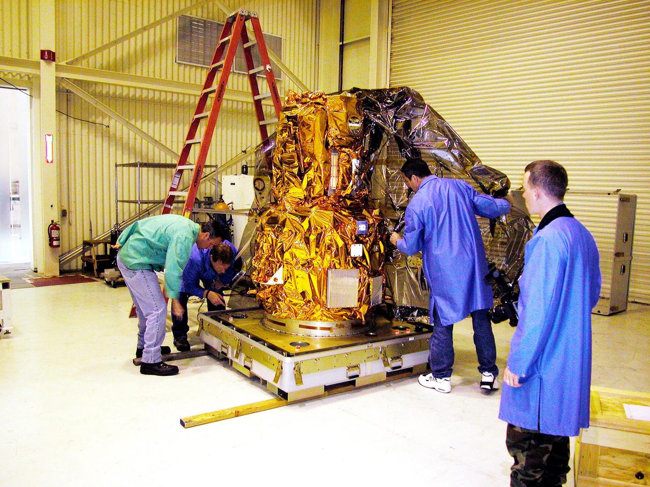 KENNEDY SPACE CENTER, FLA. - At Vandenberg Air Force Base in California, the DART (Demonstration for Autonomous Rendezvous Technology) flight demonstrator is revealed after its protective cover has been removed.  The spacecraft was developed to prove technologies for locating and maneuvering near an orbiting satellite.  Future applications of technologies developed by the DART project will benefit the nation in future space-vehicle systems development requiring in-space assembly, services or other autonomous rendezvous operations.  Designed and developed for NASA by Orbital Sciences Corporation in Dulles, Va., the DART spacecraft will be launched on a Pegasus launch vehicle. At about 40,000 feet over the Pacific Ocean, the Pegasus will be released from Orbital’s Stargazer L-1011 aircraft, fire its rocket motors and boost DART into a polar orbit approximately 472 miles by 479 miles. Once in orbit, DART will rendezvous with a target satellite, the Multiple Paths, Beyond-Line-of-Site Communications satellite, also built by Orbital Sciences. DART will then perform several close proximity operations, such as moving toward and away from the satellite using navigation data provided by onboard sensors.  DART is scheduled for launch no earlier than Oct. 18.