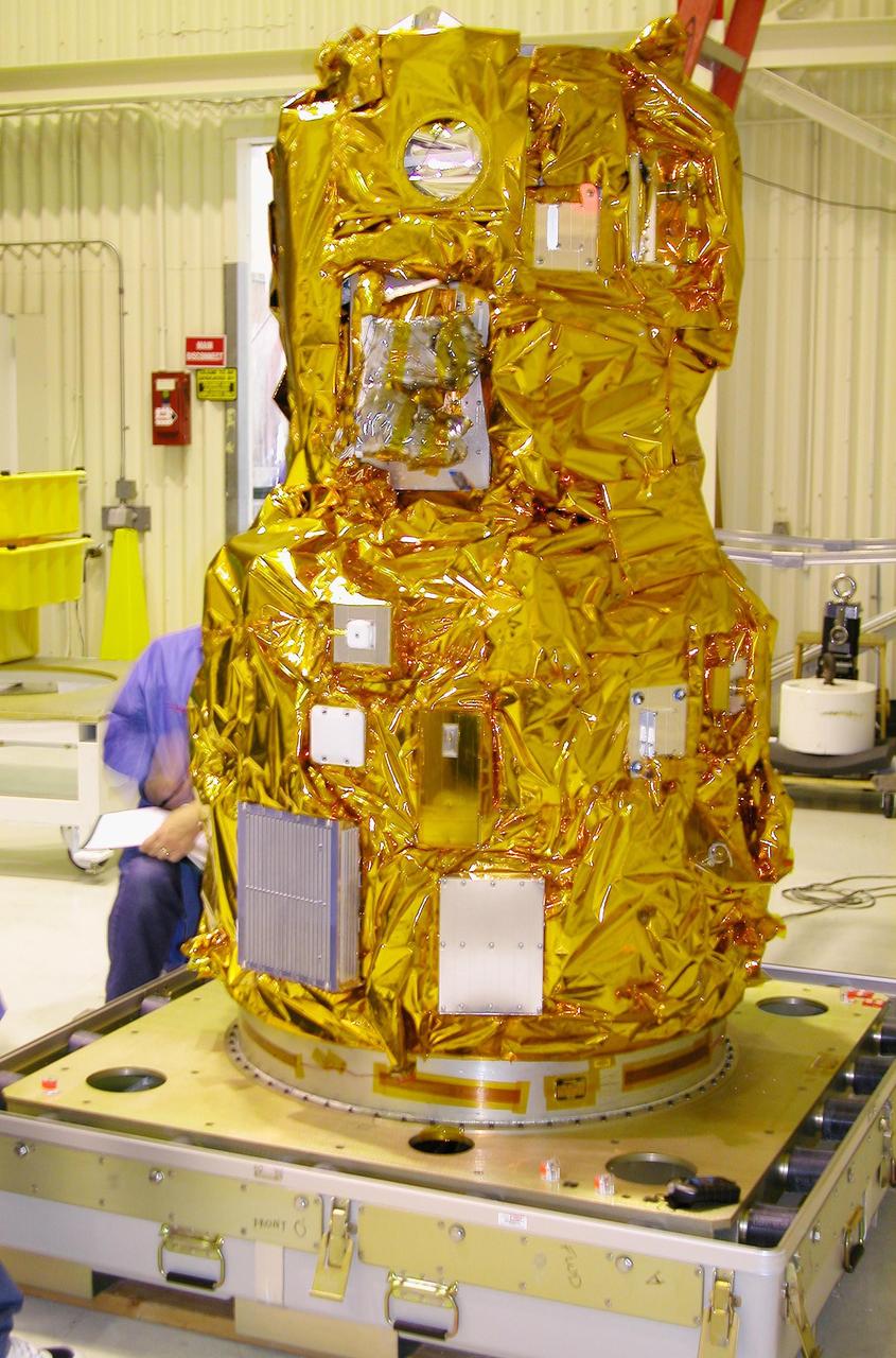 KENNEDY SPACE CENTER, FLA. - At Vandenberg Air Force Base in California, the DART (Demonstration for Autonomous Rendezvous Technology) flight demonstrator is revealed after its protective cover has been removed.  The spacecraft was developed to prove technologies for locating and maneuvering near an orbiting satellite.  Future applications of technologies developed by the DART project will benefit the nation in future space-vehicle systems development requiring in-space assembly, services or other autonomous rendezvous operations.  Designed and developed for NASA by Orbital Sciences Corporation in Dulles, Va., the DART spacecraft will be launched on a Pegasus launch vehicle. At about 40,000 feet over the Pacific Ocean, the Pegasus will be released from Orbital’s Stargazer L-1011 aircraft, fire its rocket motors and boost DART into a polar orbit approximately 472 miles by 479 miles. Once in orbit, DART will rendezvous with a target satellite, the Multiple Paths, Beyond-Line-of-Site Communications satellite, also built by Orbital Sciences. DART will then perform several close proximity operations, such as moving toward and away from the satellite using navigation data provided by onboard sensors.  DART is scheduled for launch no earlier than Oct. 18.