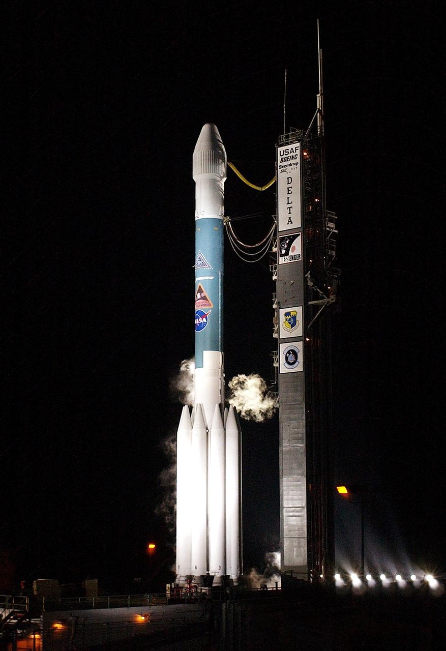 KENNEDY SPACE CENTER, FLA. - Against the clear, black sky, spotlights flood the MESSENGER spacecraft aboard a Boeing Delta II rocket as it sits ready for liftoff, scheduled for 2:15:56 a.m. EDT, from Launch Pad 17-B, Cape Canaveral Air Force Station. MESSENGER (Mercury Surface, Space Environment, Geochemistry and Ranging) is on a seven-year journey to the planet Mercury. The spacecraft will fly by Earth, Venus and Mercury several times to burn off energy before making its final approach to the inner planet on March 18, 2011. MESSENGER was built for NASA by the Johns Hopkins University Applied Physics Laboratory in Laurel, Md.