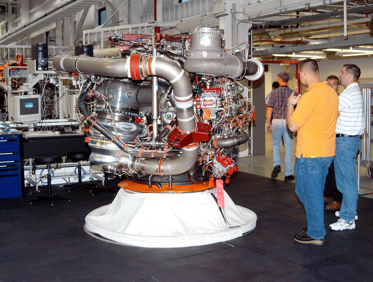 KENNEDY SPACE CENTER, FLA. - In the Space Shuttle Main Engine (SSME) Processing Facility, Boeing-Rocketdyne technicians prepare to move SSME 2058, the first SSME fully assembled at KSC. The engine will be lifted from its vertical work stand into a horizontal position in preparation for shipment to NASA’s Stennis Space Center in Mississippi to undergo a hot fire acceptance test. It is the first of five engines to be fully assembled on site to reach the desired number of 15 engines ready for launch at any given time in the Space Shuttle program. A Space Shuttle has three reusable main engines. Each is 14 feet long, weighs about 7,800 pounds, is seven-and-a-half feet in diameter at the end of its nozzle, and generates almost 400,000 pounds of thrust. Historically, SSMEs were assembled in Canoga Park, Calif., with post-flight inspections performed at KSC.  Both functions were consolidated in February 2002. The Rocketdyne Propulsion and Power division of The Boeing Co. manufactures the engines for NASA.