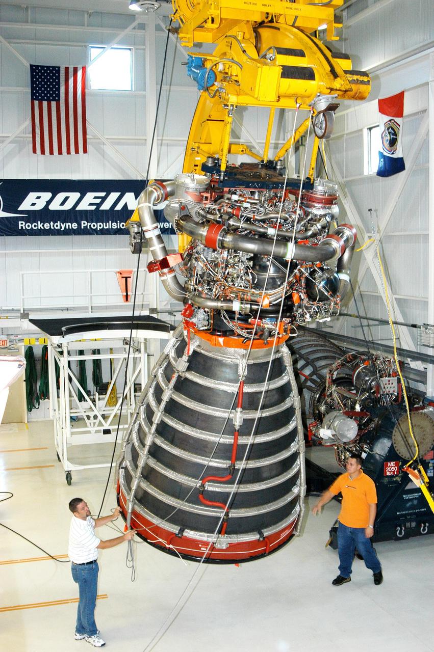 KENNEDY SPACE CENTER, FLA. - In the Space Shuttle Main Engine (SSME) Processing Facility, Boeing-Rocketdyne technicians steady SSME 2058, the first SSME fully assembled at KSC. The engine is being lifted from its vertical work stand into a horizontal position in preparation for shipment to NASA’s Stennis Space Center in Mississippi to undergo a hot fire acceptance test. It is the first of five engines to be fully assembled on site to reach the desired number of 15 engines ready for launch at any given time in the Space Shuttle program. A Space Shuttle has three reusable main engines. Each is 14 feet long, weighs about 7,800 pounds, is seven-and-a-half feet in diameter at the end of its nozzle, and generates almost 400,000 pounds of thrust. Historically, SSMEs were assembled in Canoga Park, Calif., with post-flight inspections performed at KSC.  Both functions were consolidated in February 2002. The Rocketdyne Propulsion and Power division of The Boeing Co. manufactures the engines for NASA.