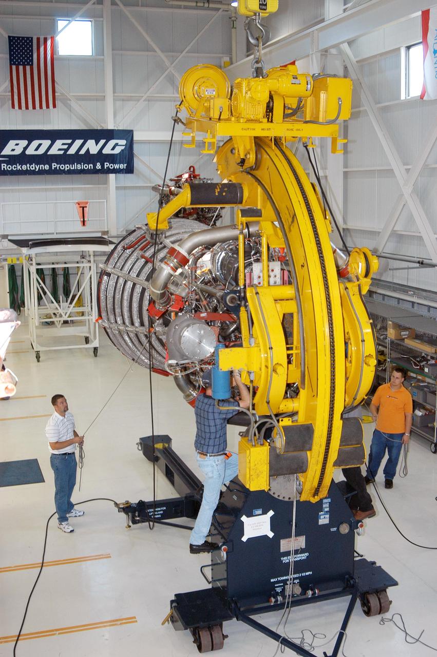 KENNEDY SPACE CENTER, FLA. - In the Space Shuttle Main Engine (SSME) Processing Facility, Boeing-Rocketdyne technicians lower SSME 2058, the first SSME fully assembled at KSC, onto an engine stand. The engine is being moved from its vertical work stand into a horizontal position in preparation for shipment to NASA’s Stennis Space Center in Mississippi to undergo a hot fire acceptance test. It is the first of five engines to be fully assembled on site to reach the desired number of 15 engines ready for launch at any given time in the Space Shuttle program. A Space Shuttle has three reusable main engines. Each is 14 feet long, weighs about 7,800 pounds, is seven-and-a-half feet in diameter at the end of its nozzle, and generates almost 400,000 pounds of thrust. Historically, SSMEs were assembled in Canoga Park, Calif., with post-flight inspections performed at KSC.  Both functions were consolidated in February 2002. The Rocketdyne Propulsion and Power division of The Boeing Co. manufactures the engines for NASA.