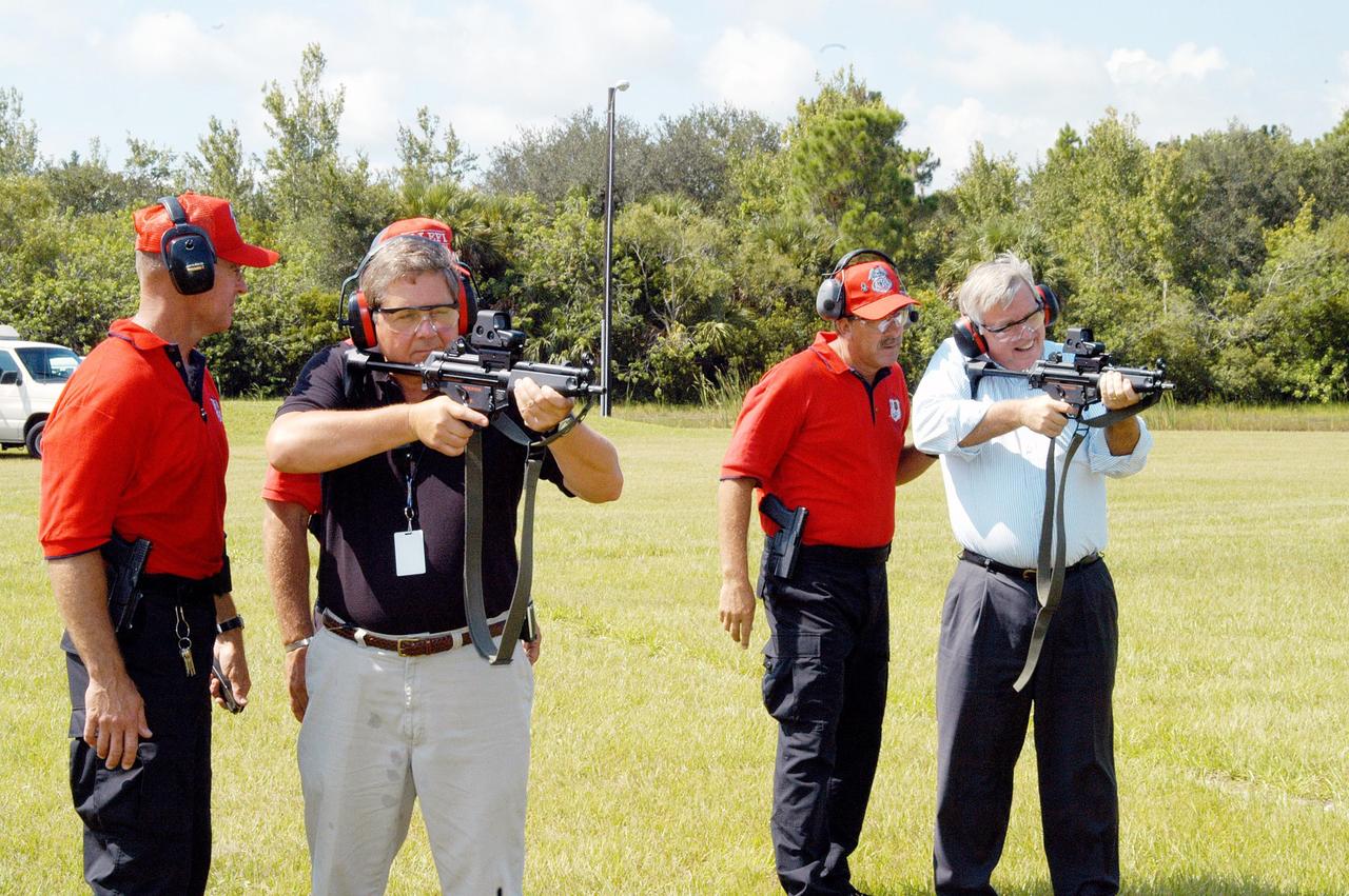 KENNEDY SPACE CENTER, FLA. - At the ribbon cutting for the Enhanced Firing Range on Schwartz Rd. at Kennedy Space Center, Dave Saleeba (left with weapon) and Center Director Jim Kennedy (right, with weapon) practice firing on the new range.  Saleeba is assistant administrator with the Office of Security Management and Safeguards at NASA Headquarters and was a guest speaker at the ceremony.  NASA’s Federal Law Enforcement Training Academy’s firing range has been upgraded to include a “rifle-grade” shoot house, a portable, tactical “shoot-back” trailer for cover and concealment drills, automated running targets and a new classroom facility.  They are added to the existing three firearms ranges, “pistol-grade” shoot house, obstacle course and rappel tower.   NASA’s Security Management and Safeguards Office funded the enhancements in order to improve ability to train the KSC security force and to support local, state and federal law enforcement agencies in Homeland Security.
