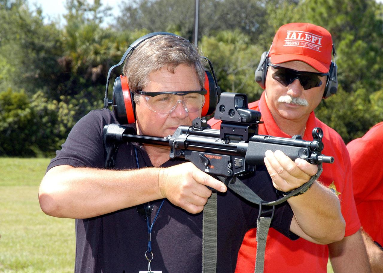 KENNEDY SPACE CENTER, FLA. - At the ribbon cutting for the Enhanced Firing Range on Schwartz Rd. at Kennedy Space Center, Dave Saleeba practices firing on the new range.  Saleeba is assistant administrator with the Office of Security Management and Safeguards at NASA Headquarters and was a guest speaker at the ceremony.  NASA’s Federal Law Enforcement Training Academy’s firing range has been upgraded to include a “rifle-grade” shoot house, a portable, tactical “shoot-back” trailer for cover and concealment drills, automated running targets and a new classroom facility.  They are added to the existing three firearms ranges, “pistol-grade” shoot house, obstacle course and rappel tower.   NASA’s Security Management and Safeguards Office funded the enhancements in order to improve ability to train the KSC security force and to support local, state and federal law enforcement agencies in Homeland Security.