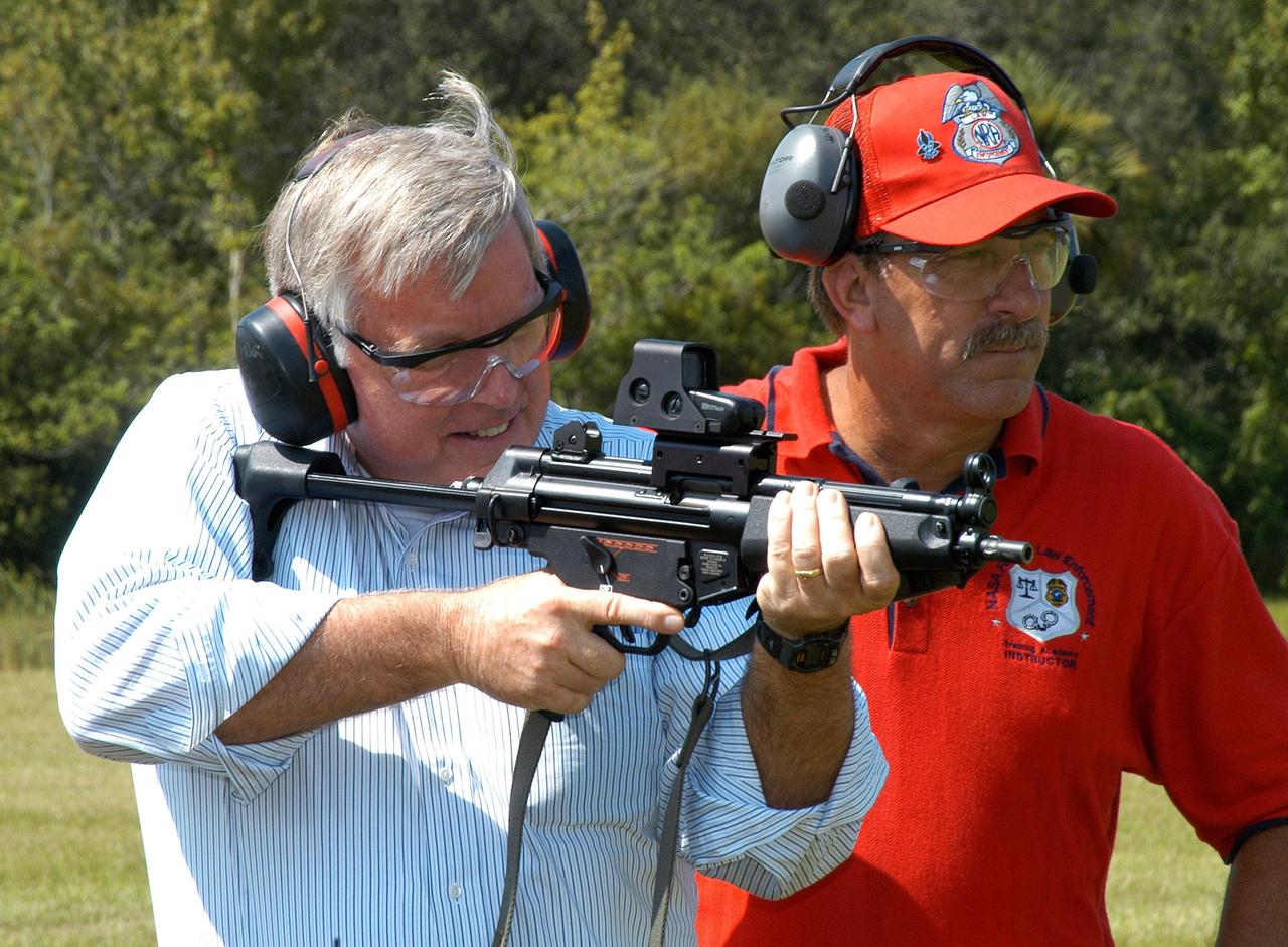 KENNEDY SPACE CENTER, FLA. - At the ribbon cutting for the Enhanced Firing Range on Schwartz Rd. at Kennedy Space Center, Center Director Jim Kennedy practices firing on the new range.  NASA’s Federal Law Enforcement Training Academy’s firing range has been upgraded to include a “rifle-grade” shoot house, a portable, tactical “shoot-back” trailer for cover and concealment drills, automated running targets and a new classroom facility.  They are added to the existing three firearms ranges, “pistol-grade” shoot house, obstacle course and rappel tower.   NASA’s Security Management and Safeguards Office funded the enhancements in order to improve ability to train the KSC security force and to support local, state and federal law enforcement agencies in Homeland Security.