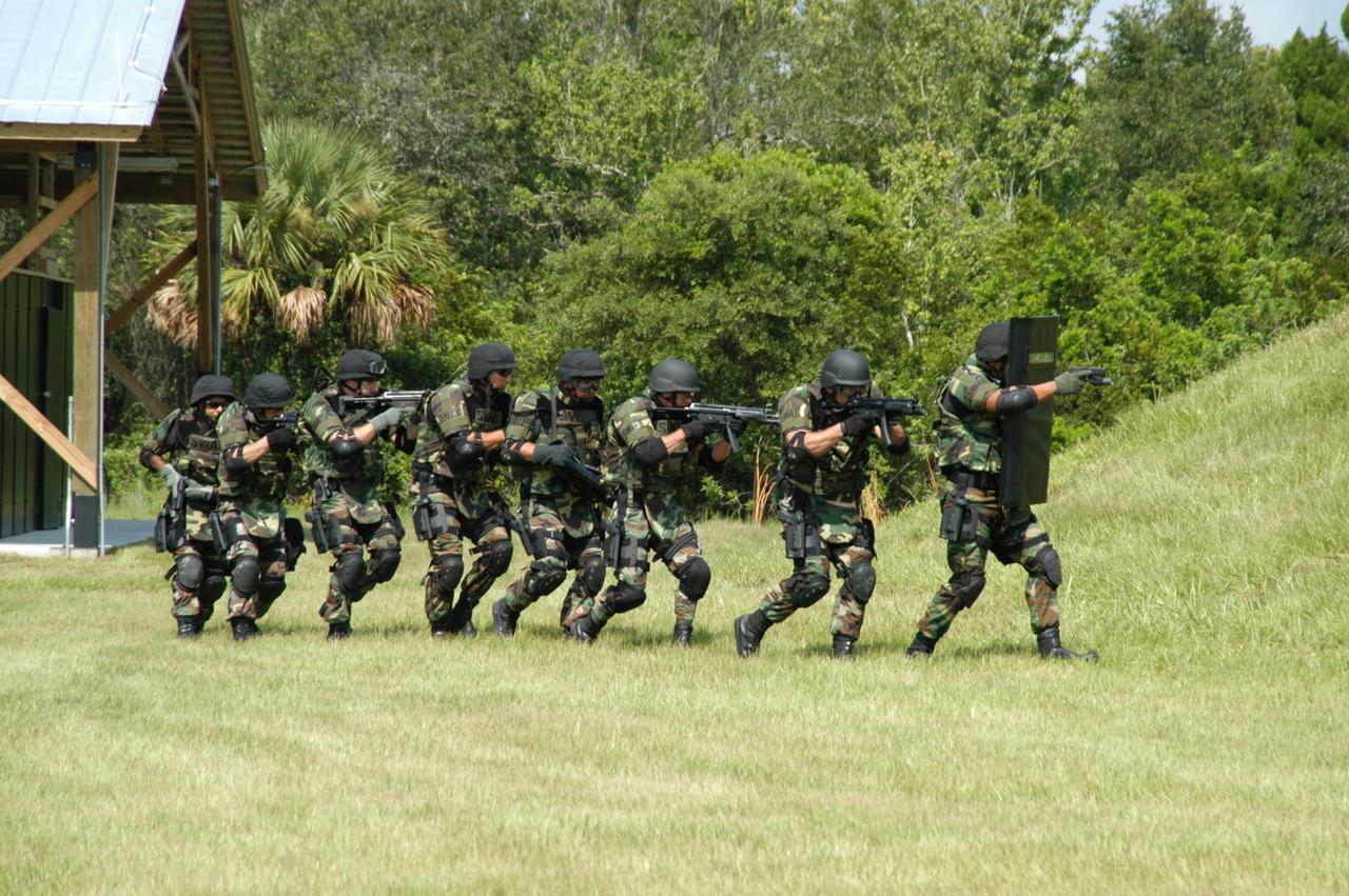 KENNEDY SPACE CENTER, FLA. - At the ribbon cutting for the Enhanced Firing Range on Schwartz Rd. at Kennedy Space Center, a SWAT team demonstrates use of the facility.  NASA’s Federal Law Enforcement Training Academy’s firing range has been upgraded to include a “rifle-grade” shoot house, a portable, tactical “shoot-back” trailer for cover and concealment drills, automated running targets and a new classroom.  They are added to the existing three firearms ranges, “pistol-grade” shoot house, obstacle course and rappel tower.   NASA’s Security Management and Safeguards Office funded the enhancements in order to improve ability to train the KSC security force and to support local, state and federal law enforcement agencies in Homeland Security.