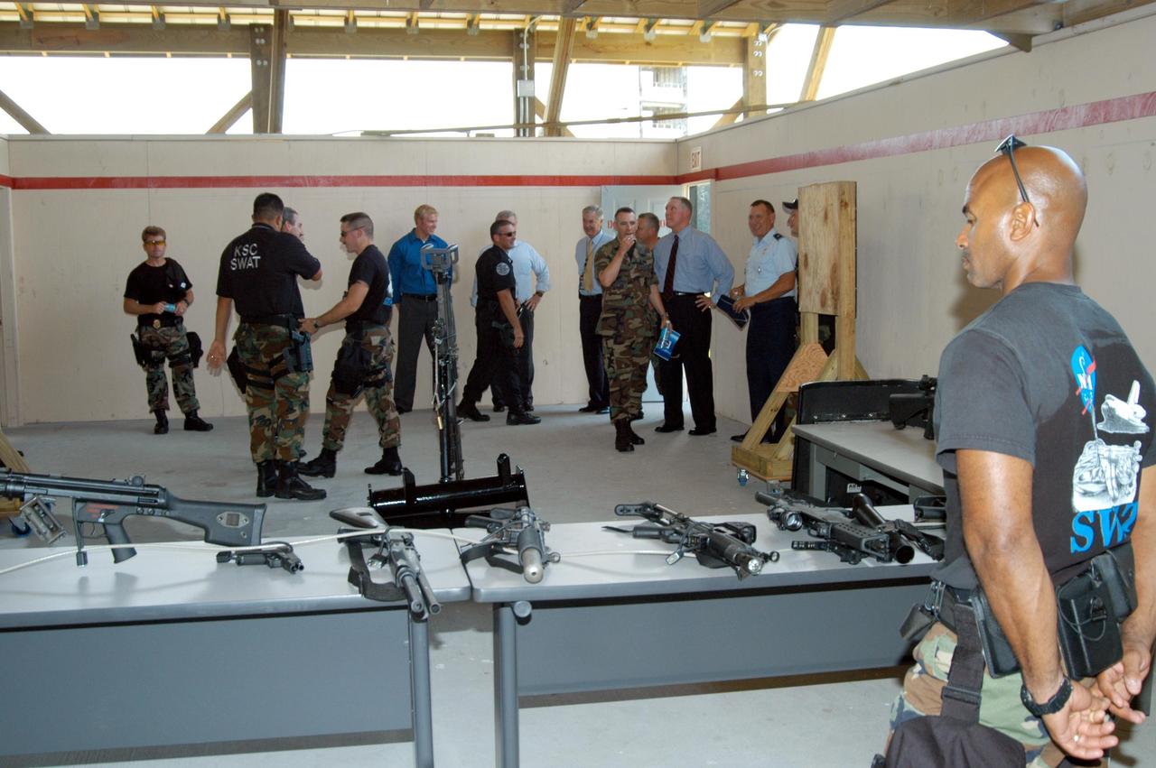 KENNEDY SPACE CENTER, FLA. - After the ribbon cutting for the Enhanced Firing Range on Schwartz Rd. at Kennedy Space Center, guests get a close look at the new “rifle-grade” shoot house.  NASA’s Federal Law Enforcement Training Academy’s firing range upgrades also include  a portable, tactical “shoot-back” trailer for cover and concealment drills, automated running targets and a new classroom.  They are added to the existing three firearms ranges, “pistol-grade” shoot house, obstacle course and rappel tower.   NASA’s Security Management and Safeguards Office funded the enhancements in order to improve ability to train the KSC security force and to support local, state and federal law enforcement agencies in Homeland Security.