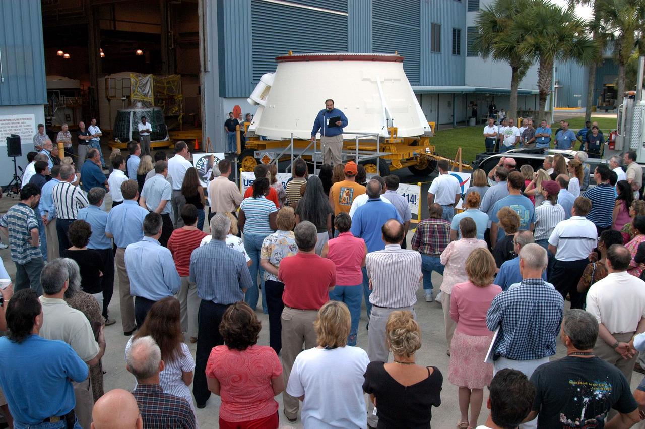 KENNEDY SPACE CENTER, FLA. - Paul Gutierrez, United Space Alliance associate program manager for the Solid Rocket Booster Element, congratulates employees in the Assembly and Refurbishment Facility for preparing the first (left) solid rocket booster aft skirt for mission STS-114 on schedule.  The segment, seen behind Gutierrez, will be transferred to the Rotation Processing and Surge Facility (RPSF) for stacking.  At the RPSF an aft motor segment and an external tank attach ring will be installed.  The stack will then be moved to the Vehicle Assembly Building for further build-up. This is the first transfer of a large piece of hardware from SRB to Ground Operations.  It is a significant milestone in the march to Return to Flight.