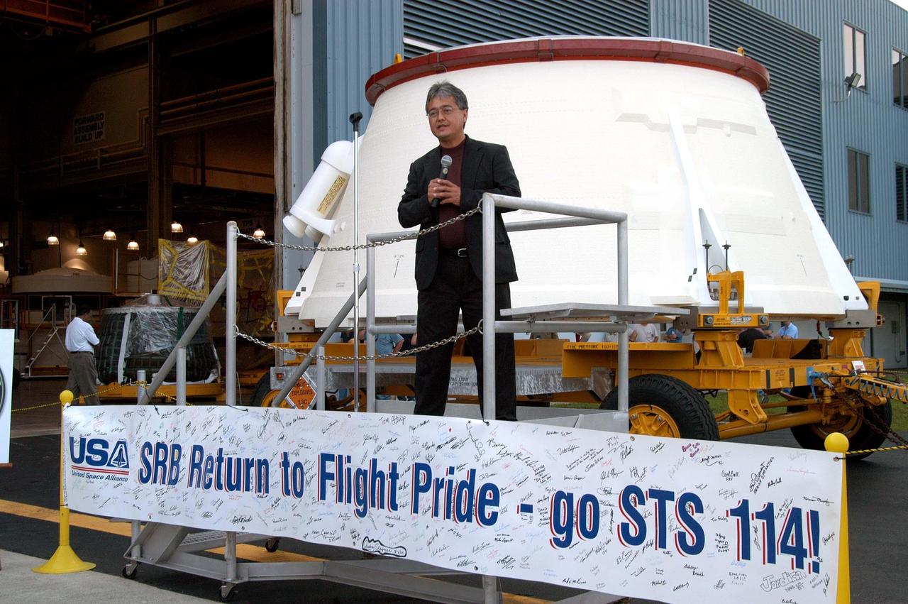 KENNEDY SPACE CENTER, FLA. - David Martin, NASA SRB project manager,  congratulates employees in the Assembly and Refurbishment Facility for preparing the first (left) solid rocket booster aft skirt for mission STS-114 on schedule.  The segment, seen behind Martin, will be transferred to the Rotation Processing and Surge Facility (RPSF) for stacking.  At the RPSF an aft motor segment and an external tank attach ring will be installed.  The stack will then be moved to the Vehicle Assembly Building for further build-up.  This is the first transfer of a large piece of hardware from SRB to Ground Operations.  It is a significant milestone in the march to Return to Flight.