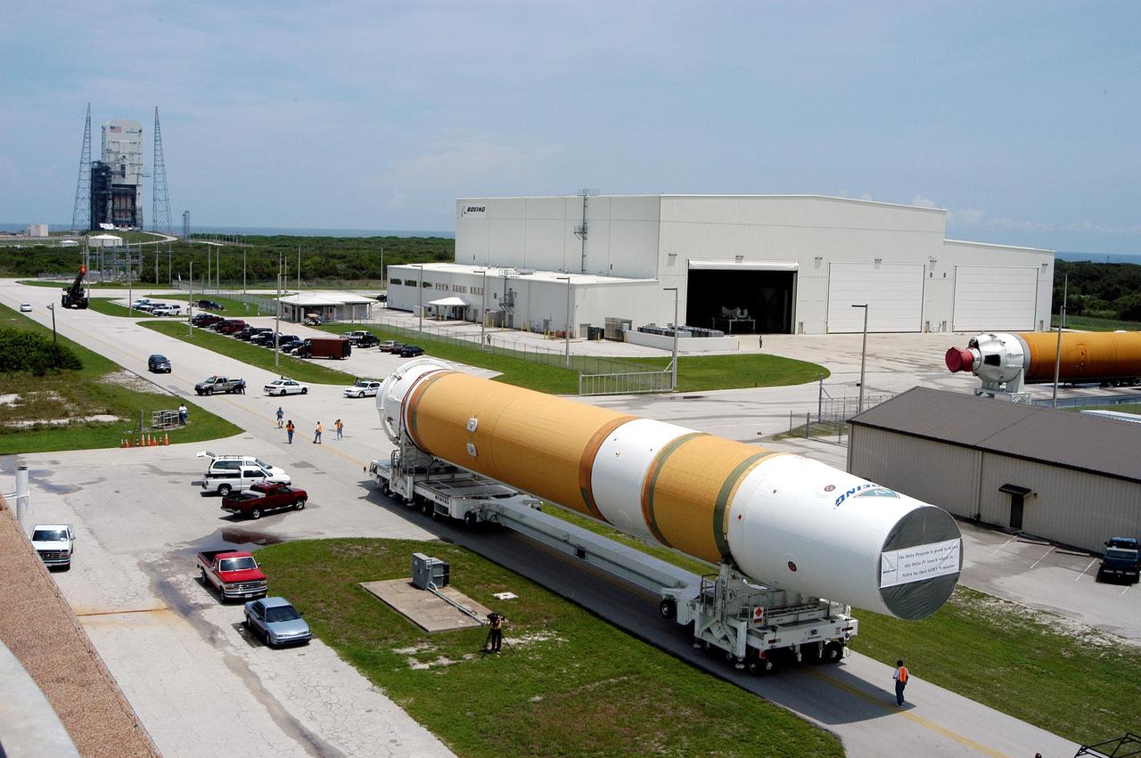 KENNEDY SPACE CENTER, FLA. - Two Boeing Delta IV first stages head to the Horizontal Integration Facility (upper right) at Launch Complex 37, Cape Canaveral Air Force Station. The rockets were shipped by barge from Decatur, Ala., to Port Canaveral and offloaded onto Elevating Platform Transporters.  A Boeing Delta IV will be used for the December launching of the GOES-N weather satellite for NASA and NOAA. The GOES-N is the first in a series of three advanced weather satellites including GOES-O and GOES-P. This satellite will provide continuous monitoring necessary for intensive data analysis. It will provide a constant vigil for the atmospheric “triggers” of severe weather conditions such as tornadoes, flash floods, hail storms and hurricanes. When these conditions develop, GOES-N will be able to monitor storm development and track their movements.