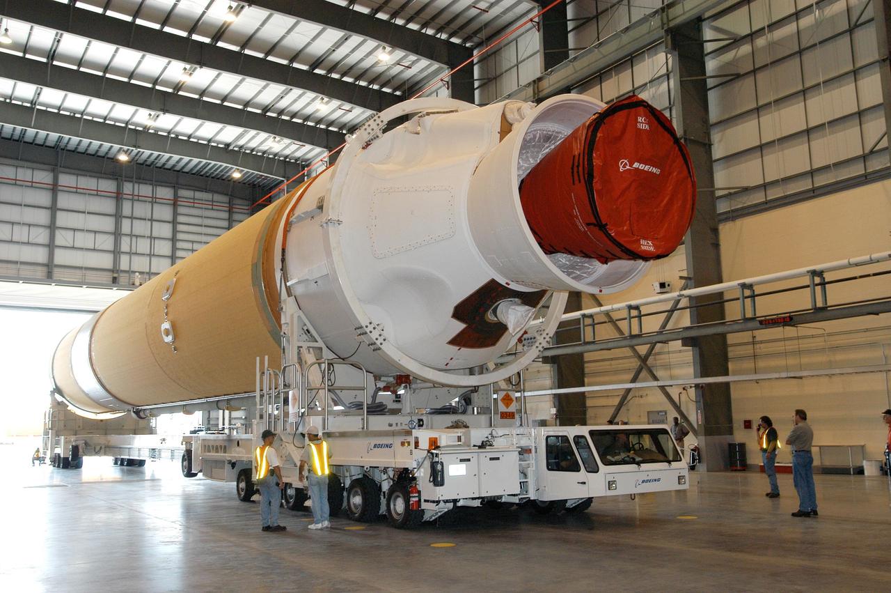 KENNEDY SPACE CENTER, FLA. - The first of two Boeing Delta IV first stages is moved inside the Horizontal Integration Facility at Launch Complex 37, Cape Canaveral Air Force Station. The rockets were shipped by barge from Decatur, Ala., to Port Canaveral and offloaded onto Elevating Platform Transporters.  .  A Boeing Delta IV will be used for the December launching of the GOES-N weather satellite for NASA and NOAA. The GOES-N is the first in a series of three advanced weather satellites including GOES-O and GOES-P. This satellite will provide continuous monitoring necessary for intensive data analysis. It will provide a constant vigil for the atmospheric “triggers” of severe weather conditions such as tornadoes, flash floods, hail storms and hurricanes. When these conditions develop, GOES-N will be able to monitor storm development and track their movements.