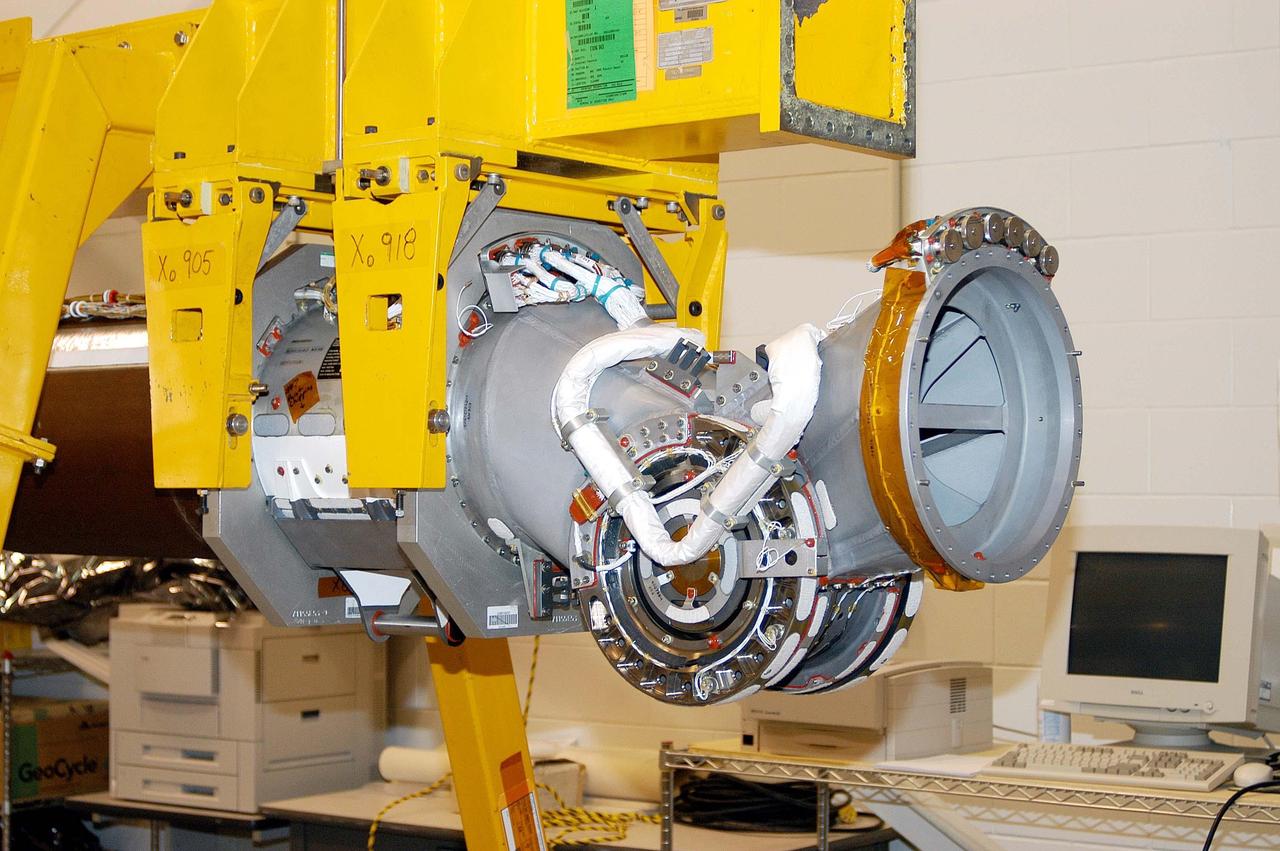 KENNEDY SPACE CENTER, FLA. - The Remote Manipulator System (RMS), also known as the Canadian robotic arm, for the orbiter Discovery has arrived at KSC’s Vehicle Assembly Building Lab.  The part seen on the end is one of the joints that allow the basic structure of the arm to maneuver similar to a human arm.  The RMS is used to deploy and retrieve payloads, provide a mobile extension ladder or foot restraints for crew members during extravehicular activities; and to aid the flight crew members in viewing surfaces of the orbiter or payloads through a television camera on the RMS. The arm The RMS is used to deploy and retrieve payloads, provide a mobile extension ladder or foot restraints for crew members during extravehicular activities; and to aid the flight crew members in viewing surfaces of the orbiter or payloads through a television camera on the RMS. The arm is also serving as the base for the new Orbiter Boom Sensor System (OBSS), one of the safety measures for Return to Flight, equipping the Shuttle with cameras and laser systems to inspect the Shuttle’s Thermal Protection System while in space.  Discovery is scheduled for a launch planning window of March 2005 on mission STS-114.