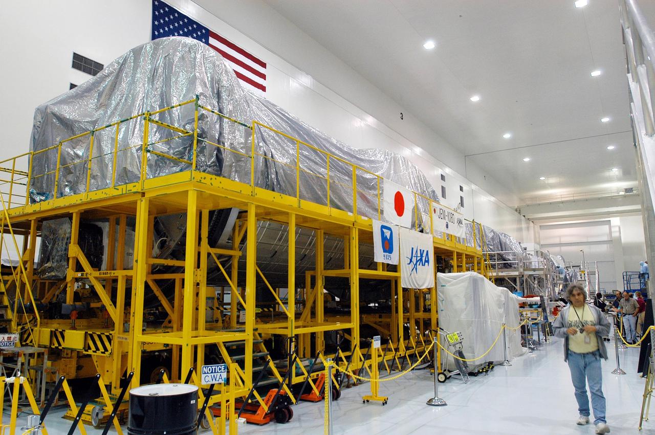 KENNEDY SPACE CENTER, FLA. -  In the Space Station Processing Facility, modules wrapped in plastic line one wall.  The modules and equipment are being covered in preparation for the expected impact of Hurricane Frances on Saturday.  KSC workers also have powered down the Space Shuttle orbiters, closed their payload bay doors and stowed the landing gear.  They are also taking precautions against flooding by moving spacecraft hardware off the ground and sandbagging facilities. The SSPF can withstand sustained winds of 110 mph and wind gusts up to 132 mph.  The Orbiter Processing Facility is constructed of concrete and steel and was designed to withstand winds of 105 mph.  The Vehicle Assembly Building is constructed of concrete and steel and was designed to withstand winds of 125 mph. Other payload and flight hardware support facilities can endure winds of 110 mph.  Launch pads and the Payload Hazardous Servicing Facility can withstand 125-mph winds.