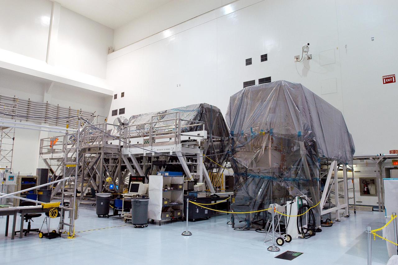 KENNEDY SPACE CENTER, FLA. -  In the Space Station Processing Facility, modules and equipment are being covered in plastic in preparation for the expected impact of Hurricane Frances on Saturday.  KSC workers also have powered down the Space Shuttle orbiters, closed their payload bay doors and stowed the landing gear.  They are also taking precautions against flooding by moving spacecraft hardware off the ground and sandbagging facilities. The SSPF can withstand sustained winds of 110 mph and wind gusts up to 132 mph.  The Orbiter Processing Facility is constructed of concrete and steel and was designed to withstand winds of 105 mph.  The Vehicle Assembly Building is constructed of concrete and steel and was designed to withstand winds of 125 mph. Other payload and flight hardware support facilities can endure winds of 110 mph.  Launch pads and the Payload Hazardous Servicing Facility can withstand 125-mph winds.