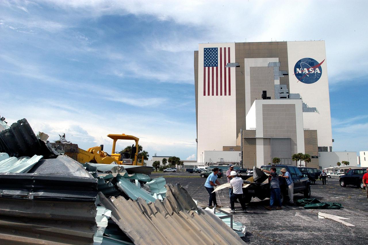KENNEDY SPACE CENTER, FLA. - Panels from the exterior walls of the Vehicle Assembly Building (VAB) are recovered by KSC employees during clean-up activities following Hurricane Frances. The storm's path over Florida took it through Cape Canaveral and KSC property during Labor Day weekend. Located in the heart of Launch Complex 39, the VAB is used for the integration and stacking of Space Shuttle elements and for the checkout and storage of External Tanks.