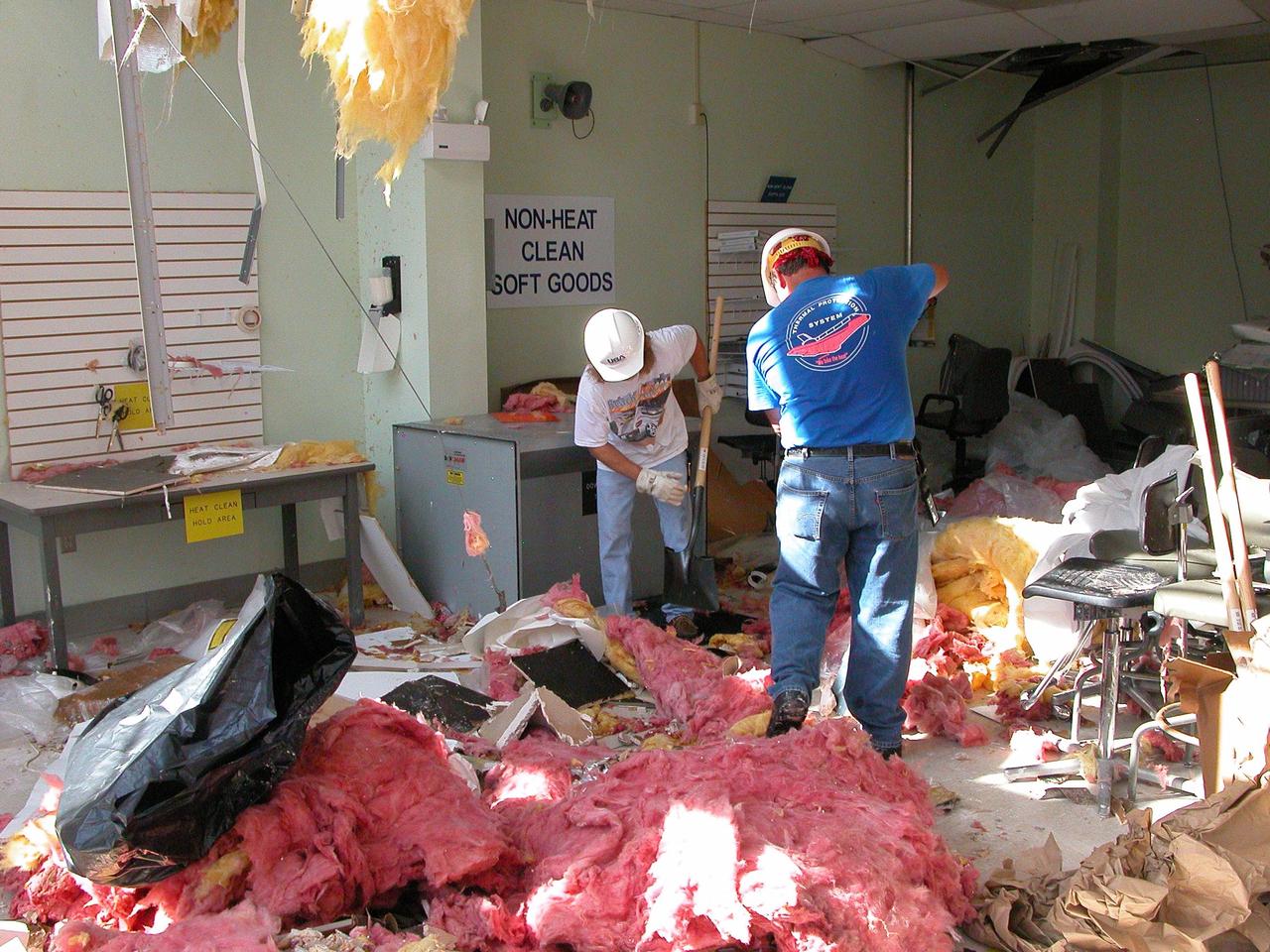 KENNEDY SPACE CENTER, FLA. -  KSC employees clean up  inside the second floor of the Thermal Protection System Facility damaged by Hurricane Frances. The storm's path over Florida took it through Cape Canaveral and KSC property during Labor Day weekend. Located in Launch Complex 39, the facility is used to manufacture both internal and external insulation products for the Space Shuttle orbiters.