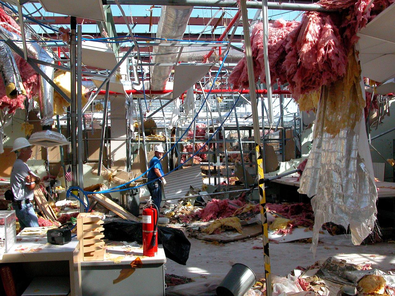 KENNEDY SPACE CENTER, FLA. - KSC employees clean up inside the second floor of the Thermal Protection System Facility damaged by Hurricane Frances. The storm's path over Florida took it through Cape Canaveral and KSC property during Labor Day weekend. Located in Launch Complex 39, the facility is used to manufacture both internal and external insulation products for the Space Shuttle orbiters.