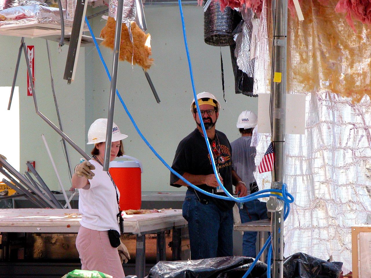 KENNEDY SPACE CENTER, FLA. -  KSC employees clean up  inside the second floor of the Thermal Protection System Facility damaged by Hurricane Frances. The storm's path over Florida took it through Cape Canaveral and KSC property during Labor Day weekend. Located in Launch Complex 39, the facility is used to manufacture both internal and external insulation products for the Space Shuttle orbiters.