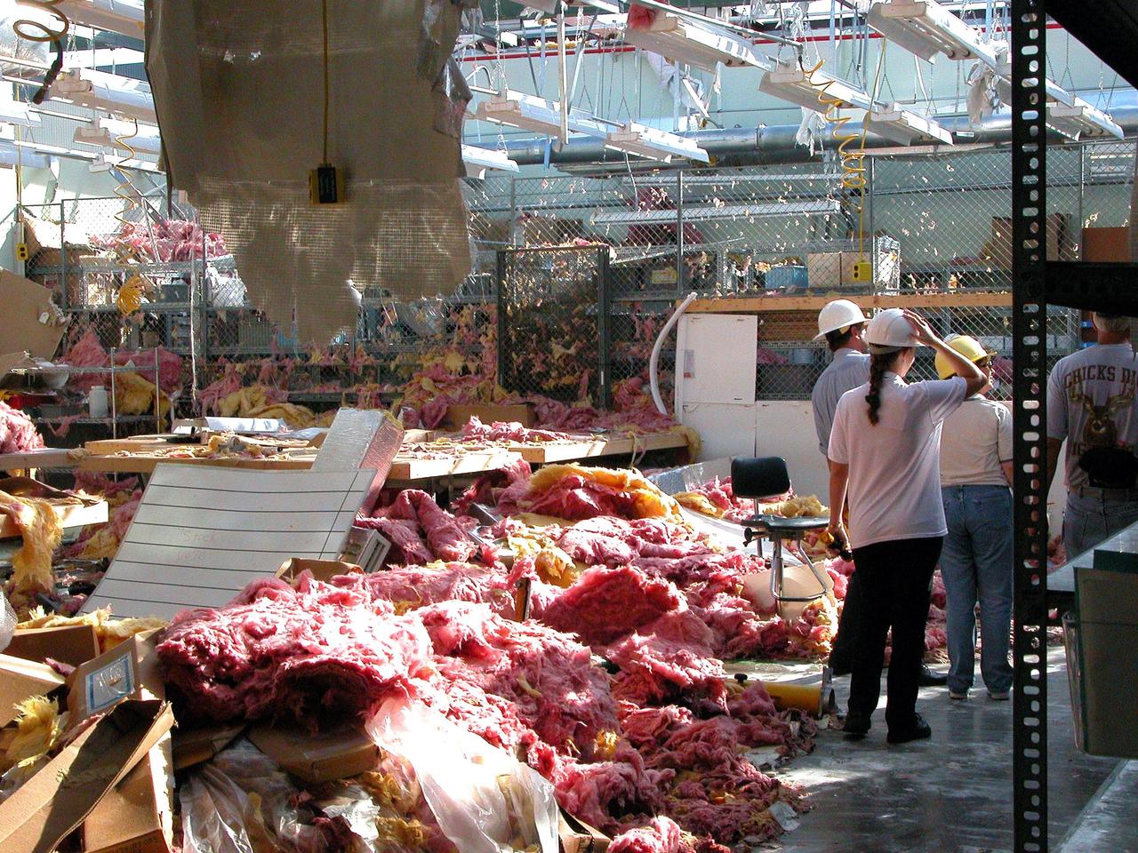 KENNEDY SPACE CENTER, FLA. -  KSC workers survey the considerable damage sustained by the second floor of the Thermal Protection System Facility from Hurricane Frances. The storm's path over Florida took it through Cape Canaveral and KSC property during Labor Day weekend. Located in Launch Complex 39, the facility is used to manufacture both internal and external insulation products for the Space Shuttle orbiters.