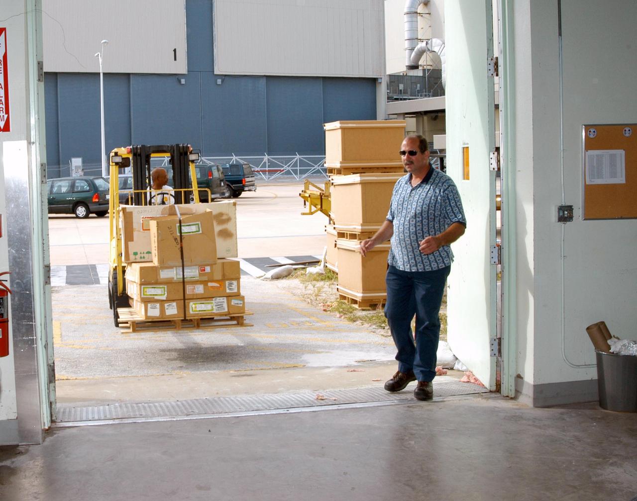 KENNEDY SPACE CENTER, FLA. -   Equipment from the Thermal Protection System Facility (TPSF), damaged by Hurricane Frances, is relocated to a hangar and storage facility near the KSC Shuttle Landing Facility. Previously, this hangar was used to house the Space Shuttle Columbia debris. Located in Launch Complex 39, the TPSF is used to manufacture both internal and external insulation products for the Space Shuttle orbiters.  The storm's path over Florida took it through Cape Canaveral and KSC property during Labor Day weekend.