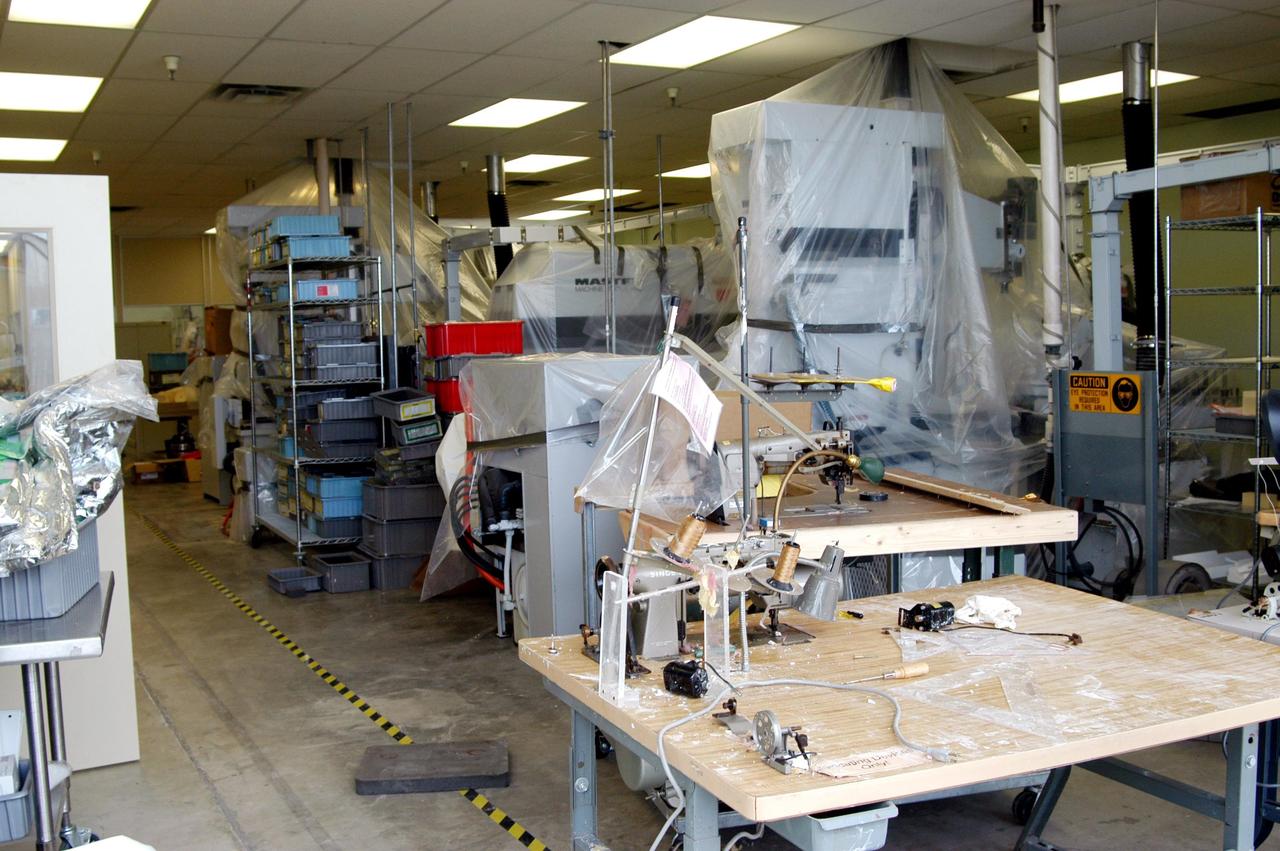 KENNEDY SPACE CENTER, FLA. -   Equipment from the Thermal Protection System Facility (TPSF), damaged by Hurricane Frances, is moved into a hangar and storage facility near the KSC Shuttle Landing Facility. Previously, this hangar was used to house the Space Shuttle Columbia debris. Located in Launch Complex 39, the TPSF is used to manufacture both internal and external insulation products for the Space Shuttle orbiters.  The storm's path over Florida took it through Cape Canaveral and KSC property during Labor Day weekend.