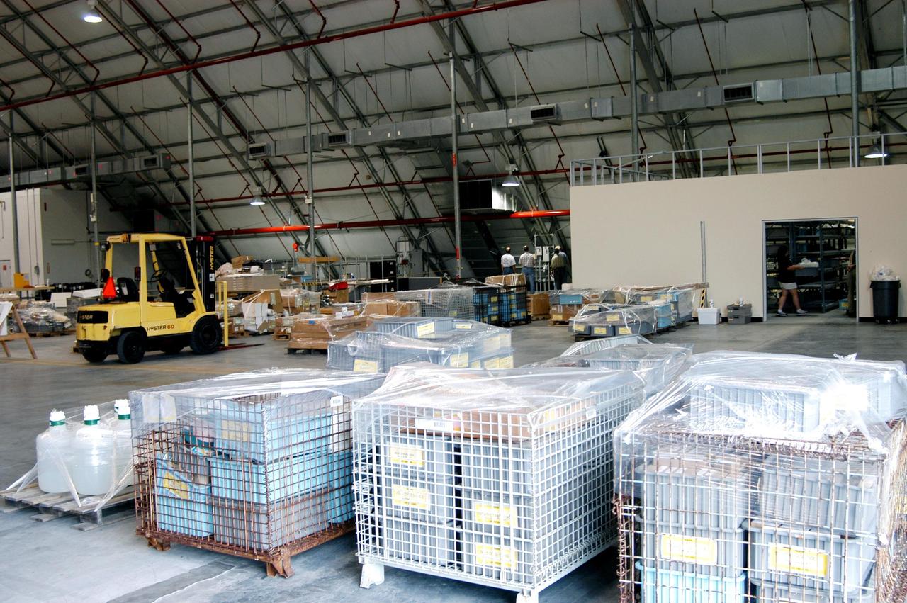 KENNEDY SPACE CENTER, FLA. -   Equipment from the Thermal Protection System Facility (TPSF), damaged by Hurricane Frances, is moved into a hangar and storage facility near the KSC Shuttle Landing Facility. Previously, this hangar was used to house the Space Shuttle Columbia debris. Located in Launch Complex 39, the TPSF is used to manufacture both internal and external insulation products for the Space Shuttle orbiters.  The storm's path over Florida took it through Cape Canaveral and KSC property during Labor Day weekend.