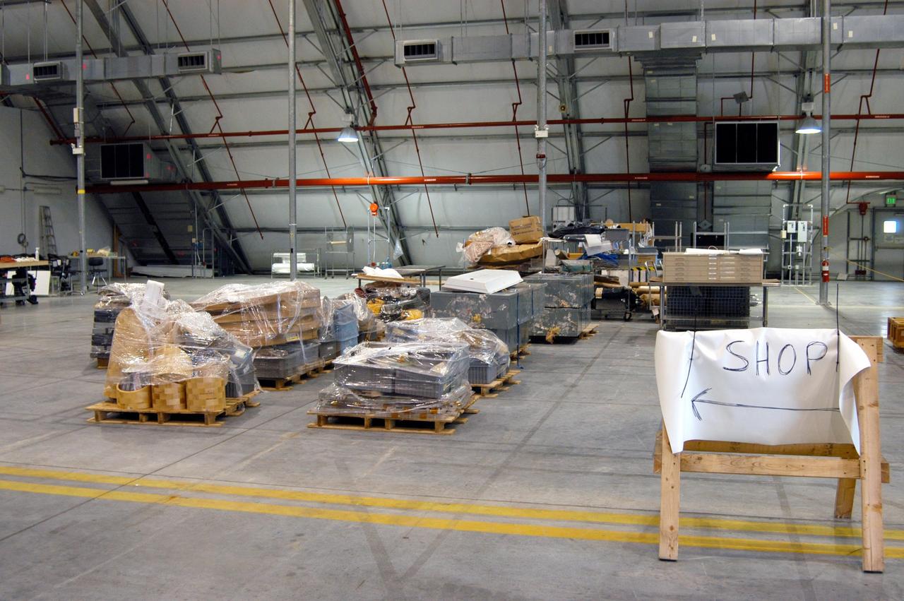 KENNEDY SPACE CENTER, FLA. -   Equipment from the Thermal Protection System Facility (TPSF), damaged by Hurricane Frances, is moved into a hangar and storage facility near the KSC Shuttle Landing Facility. Previously, this hangar was used to house the Space Shuttle Columbia debris. Located in Launch Complex 39, the TPSF is used to manufacture both internal and external insulation products for the Space Shuttle orbiters.  The storm's path over Florida took it through Cape Canaveral and KSC property during Labor Day weekend.