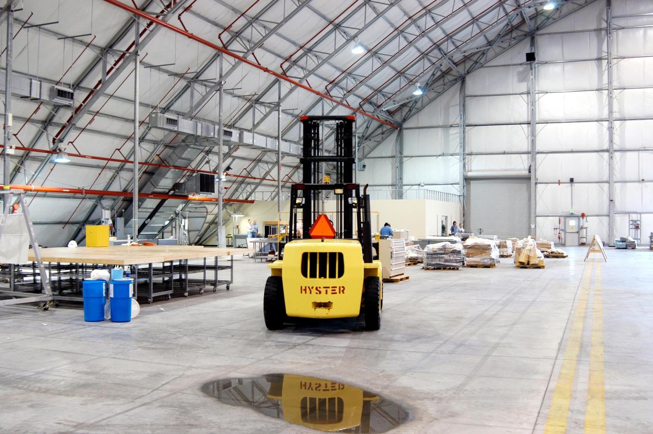 KENNEDY SPACE CENTER, FLA. -   A fork lift is available to move equipment relocated from the Thermal Protection System Facility (TPSF), damaged by Hurricane Frances, inside a hangar and storage facility near the KSC Shuttle Landing Facility. Previously, this hangar was used to house the Space Shuttle Columbia debris. Located in Launch Complex 39, the TPSF is used to manufacture both internal and external insulation products for the Space Shuttle orbiters.  The storm's path over Florida took it through Cape Canaveral and KSC property during Labor Day weekend.