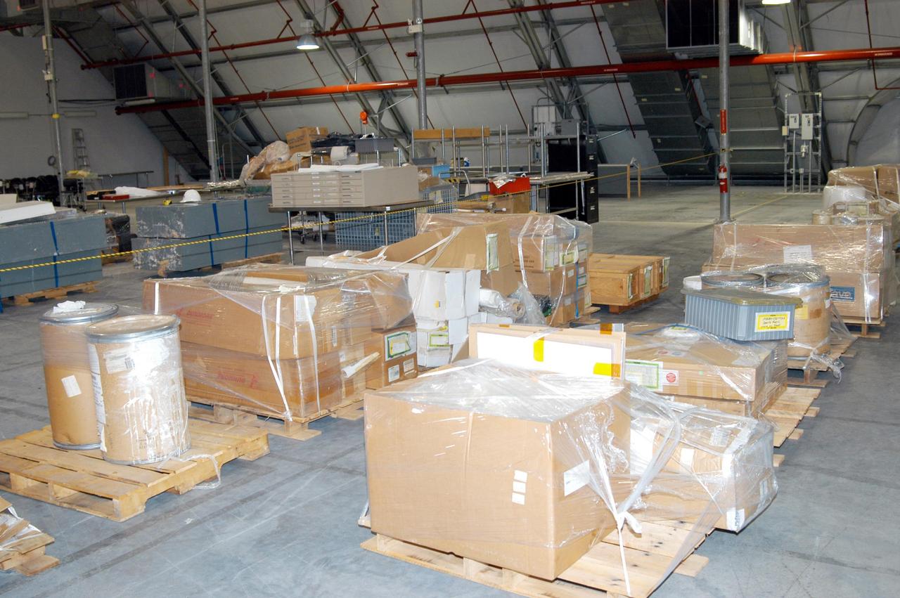 KENNEDY SPACE CENTER, FLA. -   Equipment from the Thermal Protection System Facility (TPSF), damaged by Hurricane Frances, is relocated to a hangar and storage facility near the KSC Shuttle Landing Facility. Previously, this hangar was used to house the Space Shuttle Columbia debris. Located in Launch Complex 39, the TPSF is used to manufacture both internal and external insulation products for the Space Shuttle orbiters.  The storm's path over Florida took it through Cape Canaveral and KSC property during Labor Day weekend.