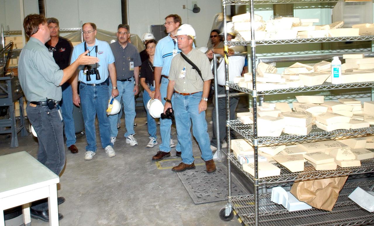 KENNEDY SPACE CENTER, FLA. -   Members of a hurricane assessment team from Johnson Space Center and Marshall Space Flight Center tour the Thermal Protection System (TPS) Facility at KSC after Hurricane Frances hit the east coast of Central Florida and Kennedy Space Center.  At left is Martin Wilson, manager of the TPS operations.  The facility, which creates the TPS tiles, blankets and all the internal thermal control systems for the Space Shuttles, is almost totally unserviceable at this time after losing approximately 35 percent of its roof.  Equipment and materials that survived the storm have been relocated to the RLV hangar near the KSC Shuttle Landing Facility.