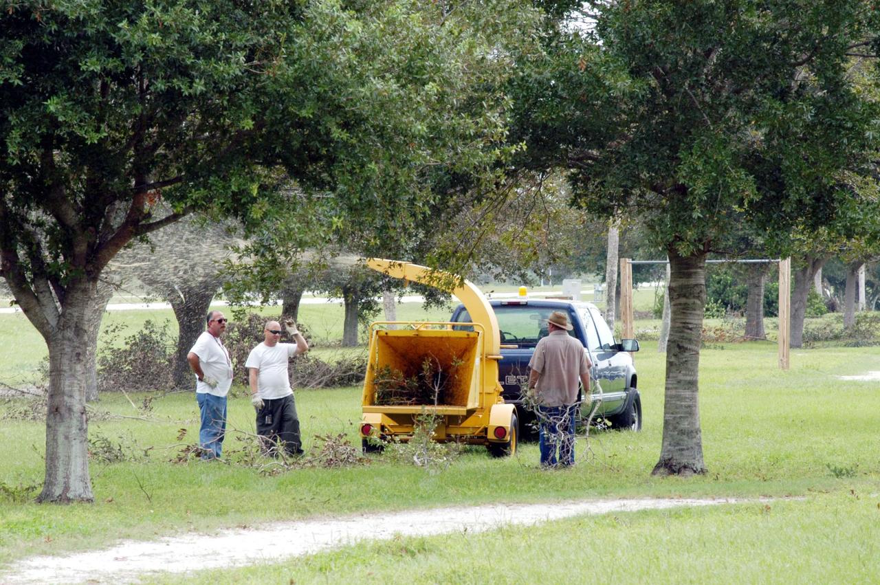 KENNEDY SPACE CENTER, FLA. -  Repair crews clean up debris left behind after Hurricane Frances as it passed over Central Florida during the Labor Day weekend. The maximum wind at the surface from Hurricane Frances was 94 mph from the northeast at 6:40 a.m. on Sunday, September 5.  It was recorded at a weather tower located on the east shore of the Mosquito Lagoon near the Cape Canaveral National Seashore.  The highest sustained wind at KSC was 68 mph.  Hurricane damage sustained at KSC included the south wall and roof of the Vehicle Assembly Building plus the roof of the Thermal Protection System Facility.