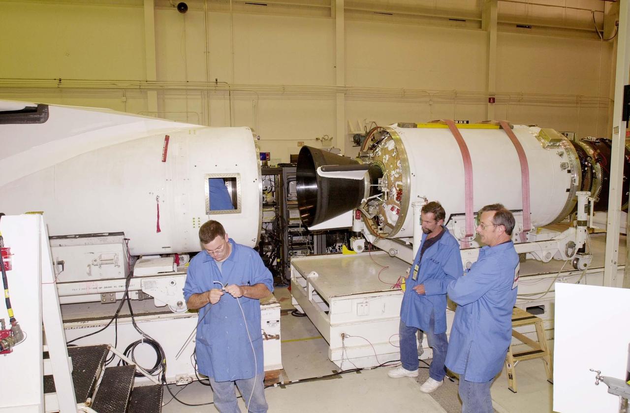 KENNEDY SPACE CENTER, FLA. - At Vandenberg Air Force Base in California, workers prepare to mate the second and third stages of the Orbital Sciences Pegasus XL launch vehicle that will launch the Demonstration of Autonomous Rendezvous Technology (DART) spacecraft. DART was designed and built for NASA by Orbital Sciences Corporation as an advanced flight demonstrator to locate and maneuver near an orbiting satellite. DART weighs about 800 pounds and is nearly 6 feet long and 3 feet in diameter. The Pegasus XL will launch DART into a circular polar orbit of approximately 475 miles. DART is designed to demonstrate technologies required for a spacecraft to locate and rendezvous, or maneuver close to, other craft in space. Results from the DART mission will aid in the development of NASA's Crew Exploration Vehicle and will also assist in vehicle development for crew transfer and crew rescue capability to and from the International Space Station.