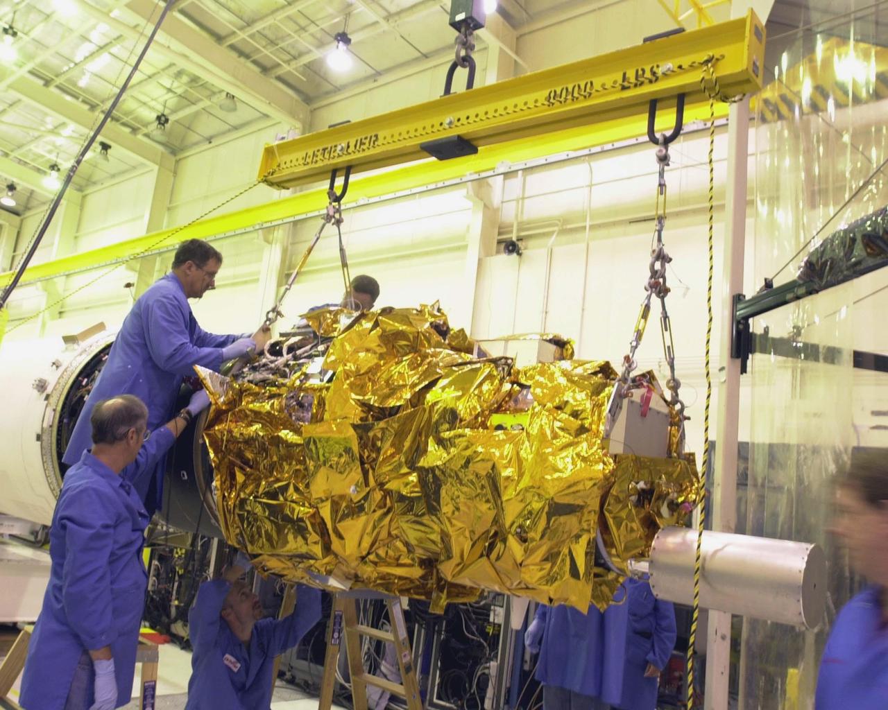 KENNEDY SPACE CENTER, FLA. - At Vandenberg Air Force Base in California, workers maneuver the Demonstration of Autonomous Rendezvous Technology (DART) spacecraft and mated upper stage toward the second stage behind them in preparation or launch aboard the Orbital Sciences Pegasus XL launch vehicle. Pegasus will launch DART into a circular polar orbit of approximately 475 miles. Built for NASA by Orbital Sciences Corporation, DART was designed as an advanced flight demonstrator to locate and maneuver near an orbiting satellite. DART weighs about 800 pounds and is nearly 6 feet long and 3 feet in diameter. DART is designed to demonstrate technologies required for a spacecraft to locate and rendezvous, or maneuver close to, other craft in space. Results from the DART mission will aid in the development of NASA’s Crew Exploration Vehicle and will also assist in vehicle development for crew transfer and crew rescue capability to and from the International Space Station.