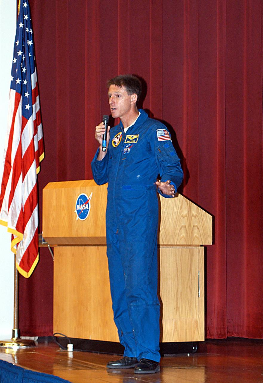 KENNEDY SPACE CENTER, FLA. -  In the Training Auditorium, astronaut Mike Foale speaks to the audience about his experiences aboard the International Space Station as commander of the Expedition 8 crew.  Foale and Flight Engineer Alexander Kaleri spent 194 days, 18 hours and 35 minutes in space, the second longest expedition to be completed aboard the Station. In February Foale and Kaleri conducted the first spacewalk ever performed from the complex by a two-person crew.   Foale has accumulated more time in space than any U.S. astronaut, amassing a total of 374 days, 11 hours and 19 minutes in space from his Expedition 8 mission, a 1997 flight to the Russian Mir Space Station, and four Space Shuttle missions.