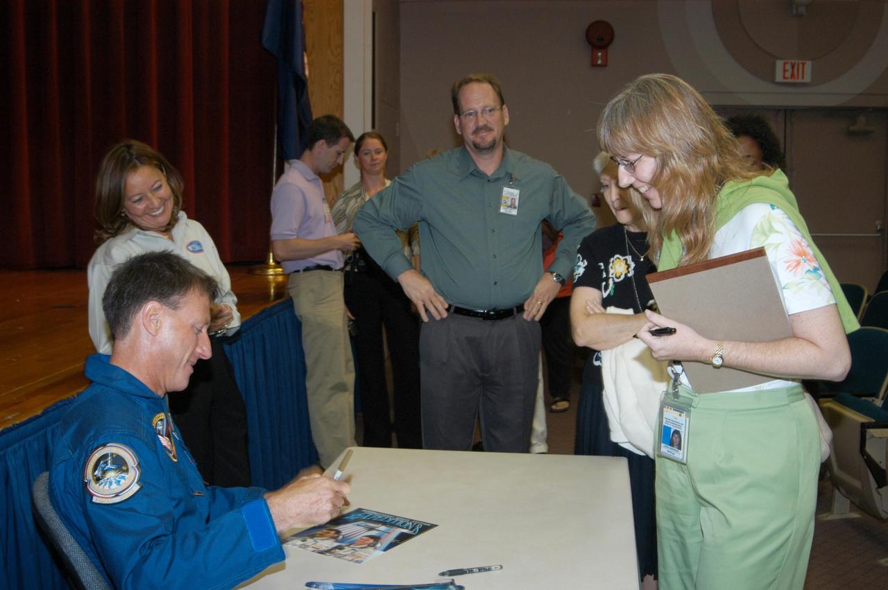 KENNEDY SPACE CENTER, FLA. -  After his presentation in the Training Auditorium, astronaut Mike Foale greets employees and signs autographs.  Foale shared his experiences aboard the International Space Station as commander of the Expedition 8 crew. Foale and Flight Engineer Alexander Kaleri spent 194 days, 18 hours and 35 minutes in space, the second longest expedition to be completed aboard the Station. In February Foale and Kaleri conducted the first spacewalk ever performed from the complex by a two-person crew.   Foale has accumulated more time in space than any U.S. astronaut, amassing a total of 374 days, 11 hours and 19 minutes in space from his Expedition 8 mission, a 1997 flight to the Russian Mir Space Station, and four Space Shuttle missions.