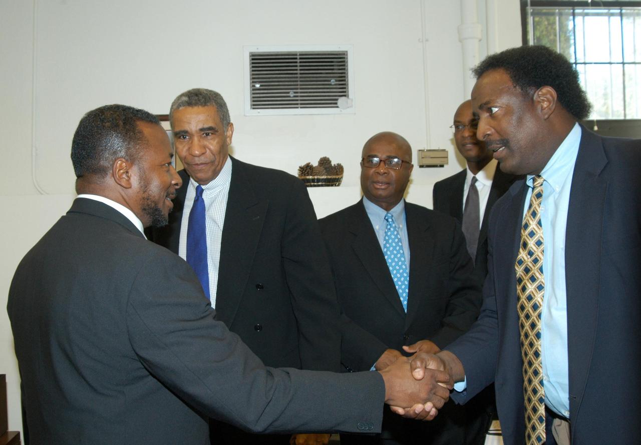 KENNEDY SPACE CENTER, FLA. - KSC Deputy Director Dr. Woodrow Whitlow Jr. (left) is welcomed by Jim Harris, principal of University Community Academy in Atlanta, a NASA Explorer School. Dr. Whitlow is visiting the school to share the vision for space exploration with the next generation of explorers. Whitlow talked with students about our destiny as explorers, NASA’s stepping stone approach to exploring Earth, the Moon, Mars and beyond, how space impacts our lives, and how people and machines rely on each other in space. Melvin talked about the importance of teamwork and what it takes for mission success.