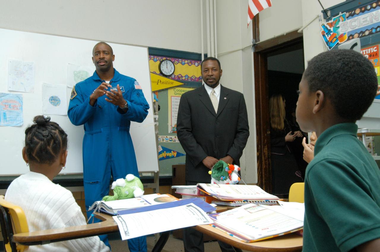 KENNEDY SPACE CENTER, FLA. - At University Community Academy in Atlanta, a NASA Explorer School, astronaut Leland Melvin talks to students. Melvin accompanied KSC Deputy Director Dr. Woodrow Whitlow Jr. (right), who was visiting the school to share the vision for space exploration with the next generation of explorers. Whitlow talked with students about our destiny as explorers, NASA’s stepping stone approach to exploring Earth, the Moon, Mars and beyond, how space impacts our lives, and how people and machines rely on each other in space. Melvin talked about the importance of teamwork and what it takes for mission success.