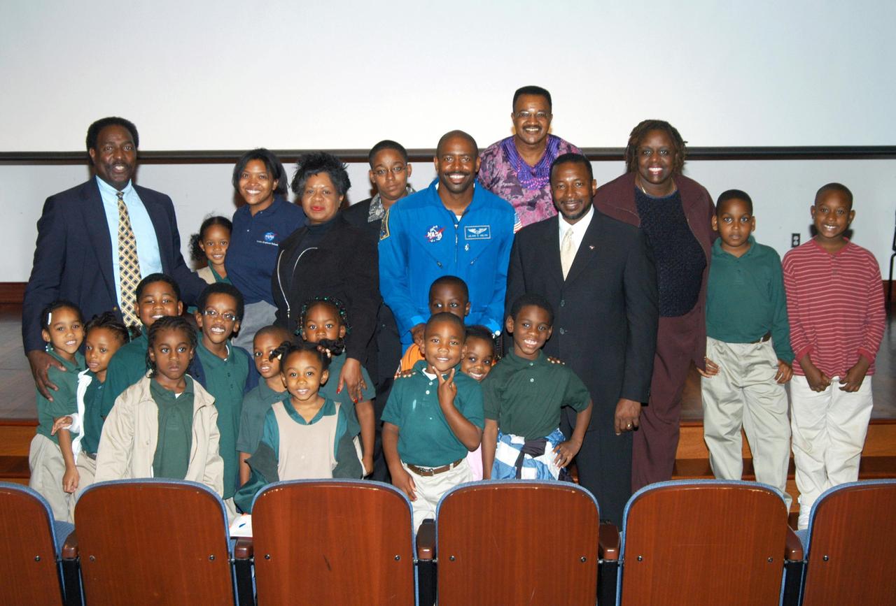 KENNEDY SPACE CENTER, FLA. - At University Community Academy in Atlanta, a NASA Explorer School, KSC Deputy Director Dr. Woodrow Whitlow Jr. (fourth from right) and astronaut Leland Melvin (fifth from right) stand for a group photo with students and staff members. At far left is Jim Harris, principal of the school. Dr. Whitlow was visiting the school to share the vision for space exploration with the next generation of explorers. Whitlow talked with students about our destiny as explorers, NASA’s stepping stone approach to exploring Earth, the Moon, Mars and beyond, how space impacts our lives, and how people and machines rely on each other in space. Also on the tour, Melvin talked about the importance of teamwork and what it takes for mission success.