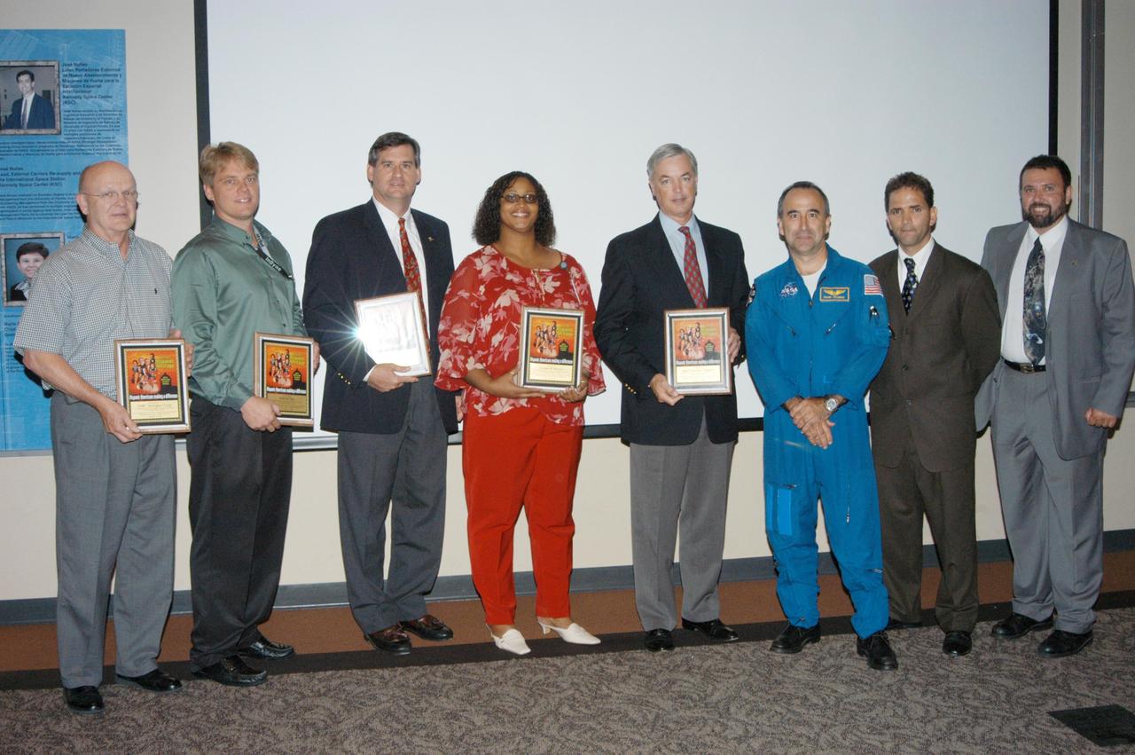 KENNEDY SPACE CENTER, FLA. -  At KSC’s annual Hispanic American Heritage luncheon, contractor sponsors were presented certificates of appreciation.  Accepting were  (from left) Dick Lyons, with ASRC Aerospace Corp.; Tom Niemeyer, with InDyne Corp.; Kevin Hoshstrasser (with Boeing); Vera Pettis, with Lockheed Martin; and Bill Sample, with SGS.  Next to them are astronaut Fernando Caldeiro, Felix A. Soto Toro and Joseph Tellado.  Soto Toro and Tellado were co-chairs of the event hosted by the Hispanic Employment Program Working Group. The annual event helps employees reflect on the extensive contributions Hispanics have made to KSC, NASA and the nation.