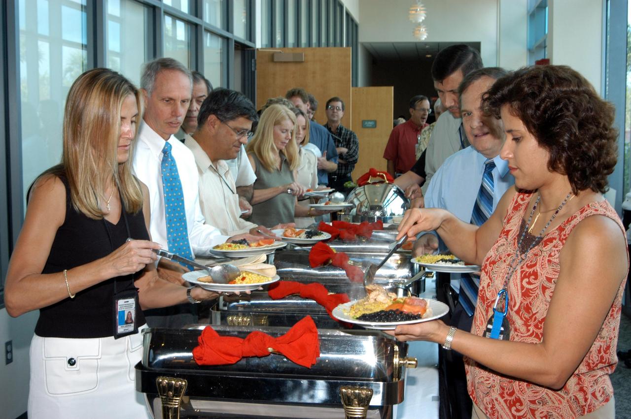 KENNEDY SPACE CENTER, FLA. - In the Debus Center at the KSC Visitor Complex, employees help themselves to a variety of Hispanic foods during the Center’s annual Hispanic American Heritage luncheon.  The theme was “Hispanic Americans Making a Difference” and featured guest speaker Charles A. Gambaro, NASA KSC engineering lead and Combat Engineering Group commander, who recently returned from Operation Iraqi Freedom.  Hosted by the Hispanic Employment Program Working Group, the luncheon also provided live cultural entertainment.  The annual event helps employees reflect on the extensive contributions Hispanics have made to KSC, NASA and the nation.