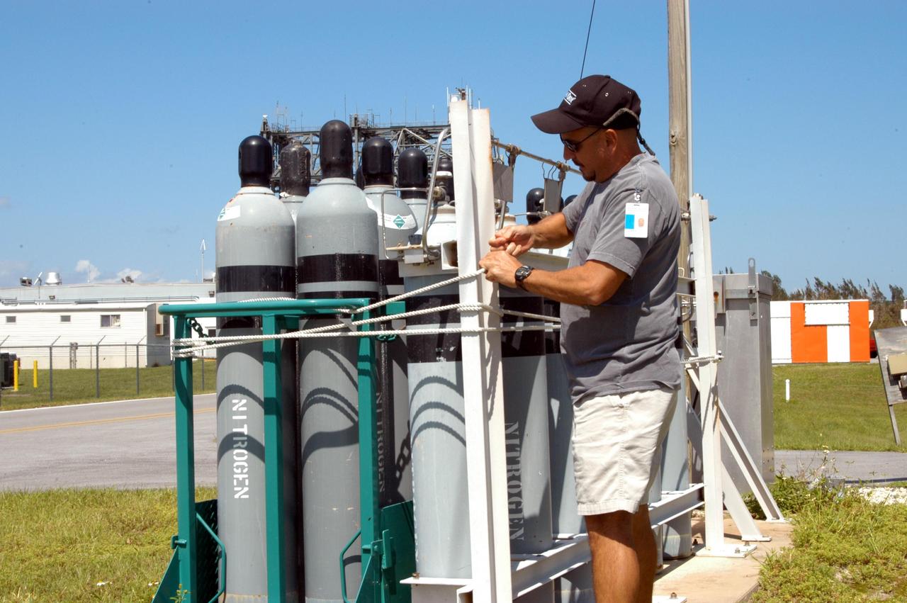 KENNEDY SPACE CENTER, FLA. - A worker secures tanks in preparation for the arrival of Hurricane Jeanne, expected to impact Central Florida Sunday. This is the fourth hurricane in 45 days to make landfall somewhere in the state.