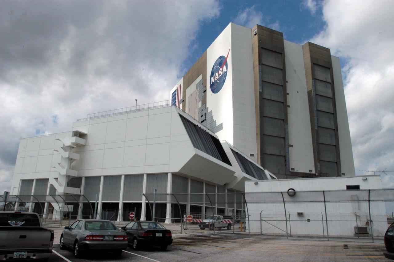 KENNEDY SPACE CENTER, FLA. - A helicopter moves past the Vehicle Assembly Building at KSC following the category 3 Hurricane Jeanne. The storm barreled through Central Florida Sept. 25-26 from the southeast. The VAB had lost 850 panels from the south wall during Hurricane Frances. Twenty-five additional panels were pulled off the east wall by the winds from Jeanne. This was the fourth hurricane in 6 weeks to batter the state.