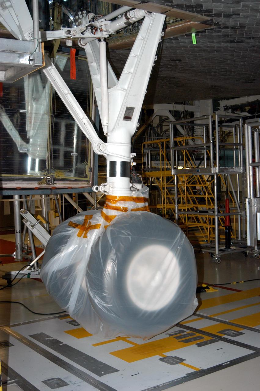 KENNEDY SPACE CENTER, FLA. - - In the Orbiter Processing Facility, the wheel on Atlantis is covered in plastic that protected it from possible damage by Hurricane Jeanne. The storm barreled through Central Florida Sept. 25-26 from the southeast. This was the fourth hurricane in 6 weeks to batter the state.