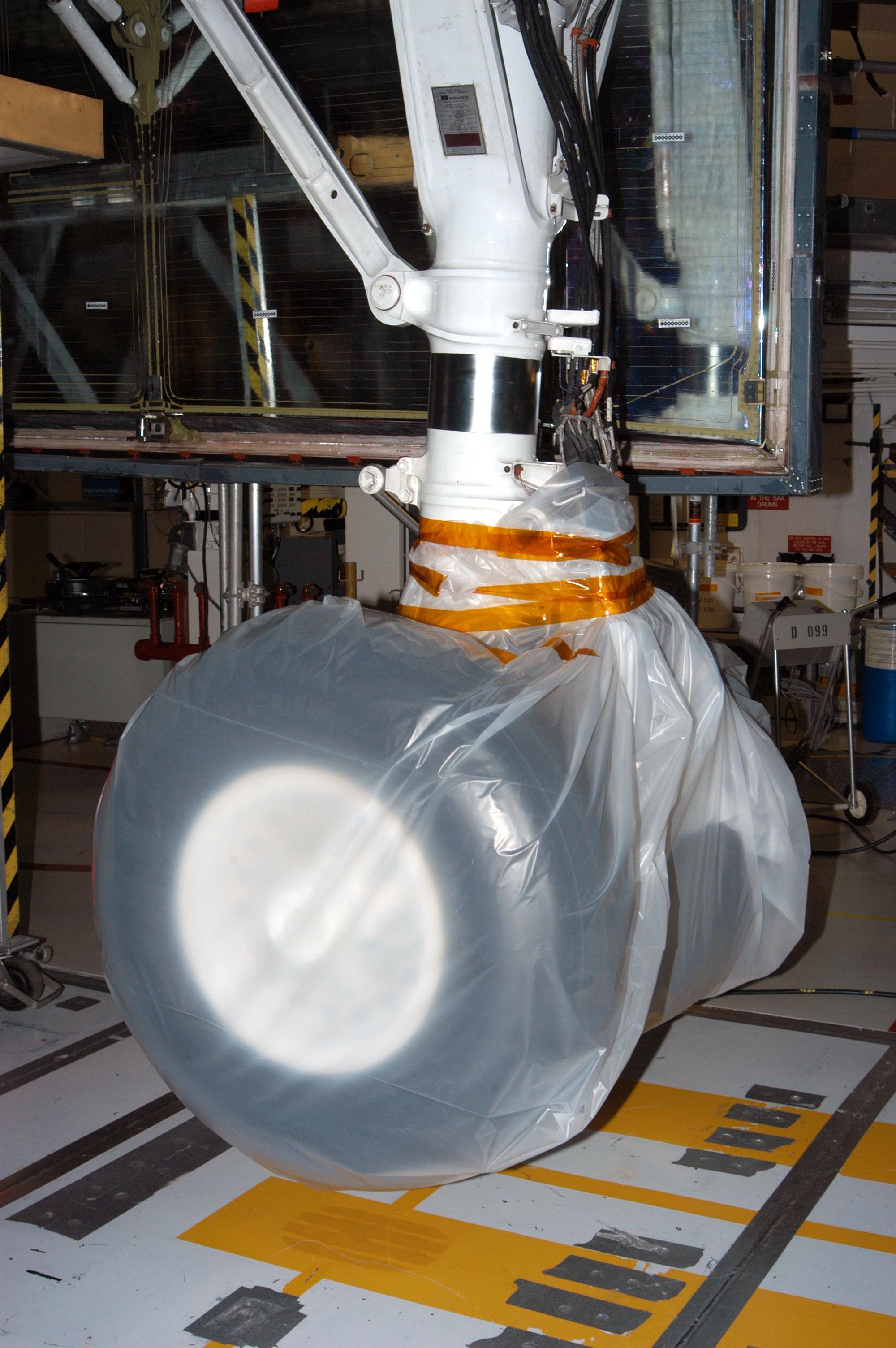 KENNEDY SPACE CENTER, FLA. - In the Orbiter Processing Facility, the wheel on Atlantis is covered in plastic that protected it from possible damage by Hurricane Jeanne.  The storm ravaged Central Florida for 21 hours as it crossed the shoreline on the east coast Sept. 25-26.  This was the fourth hurricane in 6 weeks to batter the state.