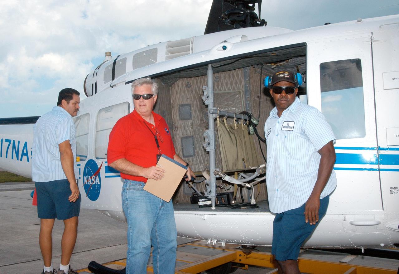 KENNEDY SPACE CENTER, FLA. - Center Director James Kennedy (center) prepares to board a helicopter to observe damage from Hurricane Jeanne. A category 3 storm, Jeanne barreled through Central Florida Sept. 25-26, the fourth hurricane in 6 weeks to batter the state.