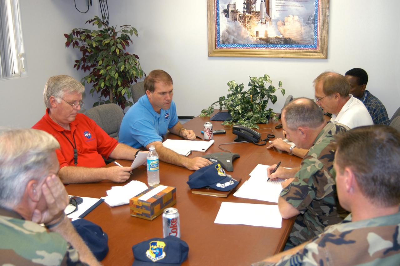 KENNEDY SPACE CENTER, FLA. - The Damage Assessment Recovery Team (DART) meets at the NASA KSC News Center following Hurricane Jeanne.  At left (red shirt) is Center Director Jim Kennedy and Media Services Division Chief Mike Rein.  A category 3 storm, Jeanne barreled through Central Florida Sept. 25-26,  the fourth hurricane in 6 weeks to batter the state.