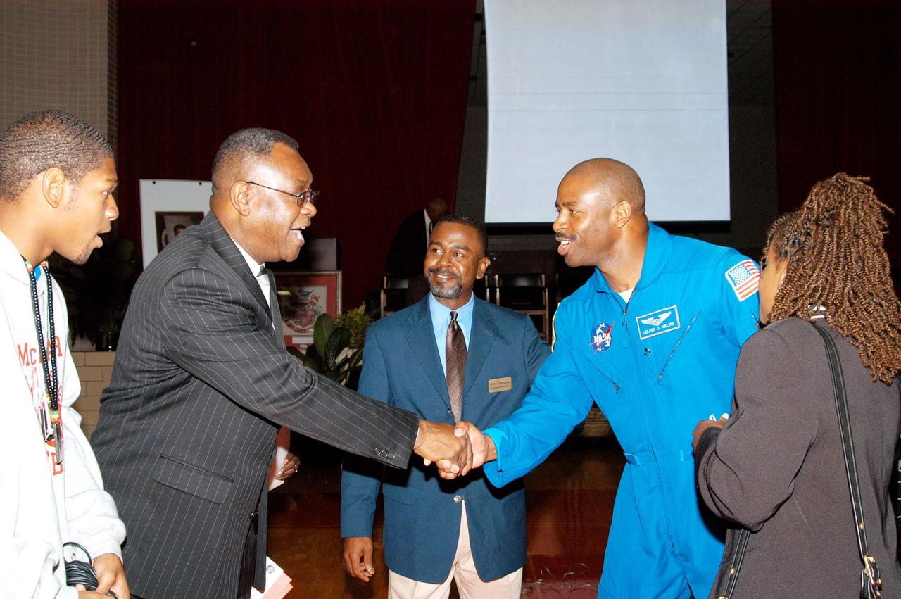 KENNEDY SPACE CENTER, FLA. -  A school board member of Ronald E. McNair High School in Atlanta welcomes astronaut Leland Melvin (second from right) to the school.  McNair is one of NASA’s Explorer Schools. Melvin accompanied KSC Deputy Director Dr. Woodrow Whitlow Jr. on a visit to the school to share the vision for space exploration with the next generation of explorers.  Whitlow  talked with students about our destiny as explorers, NASA’s stepping stone approach to exploring Earth, the Moon, Mars and beyond, how space impacts our lives, and how people and machines rely on each other in space.